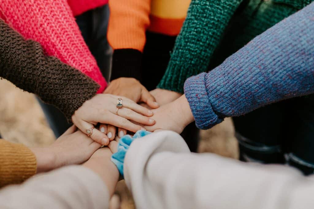 A group of people with their hands piled in the center.