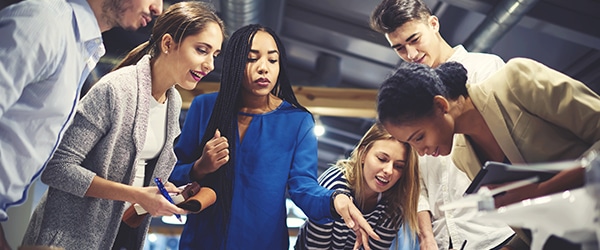 A group of employees working collaboratively at an office to increase company profits