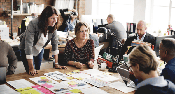 A group of employees working collaboratively with sticky notes.