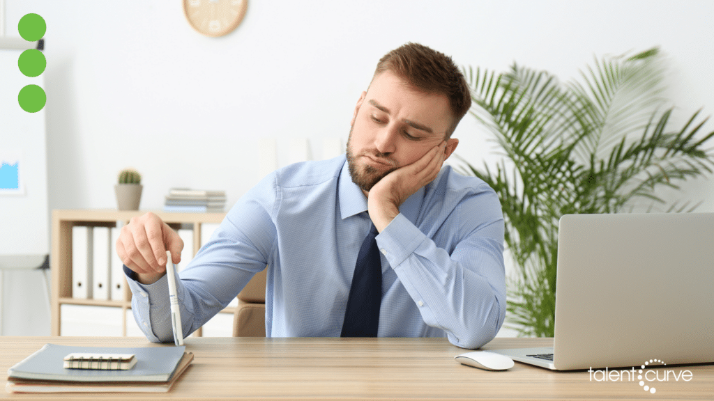 disgruntled employees sitting at his desk bored